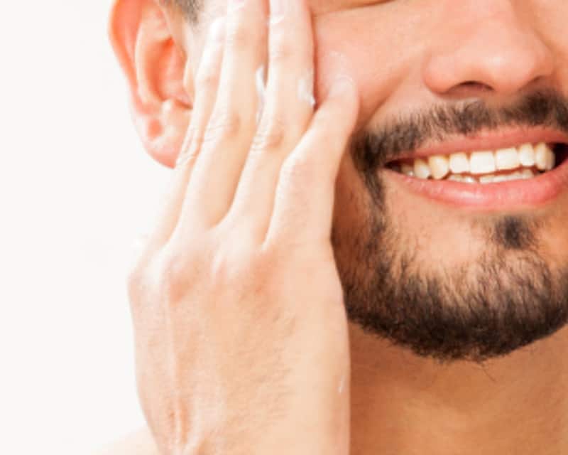 A man's face rubbing in shaving cream to prevent razor burn.