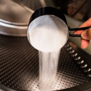 Adding baking soda to the drum of a front loader washer.