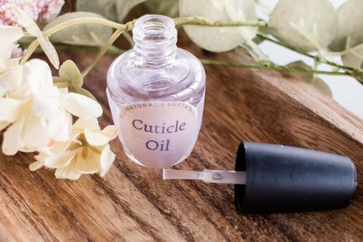 Cuticle oil for nails in a small glass container.