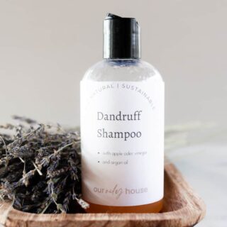 Homemade dandruff shampoo in a repurposed pop top bottle.