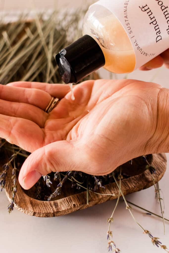 Pouring homemade dandruff shampoo on the hands. 