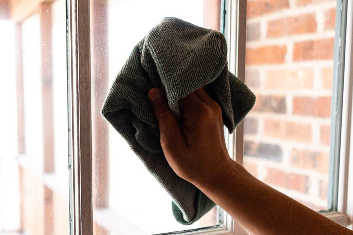 Cleaning windows with vinegar and a microfiber cloth. 