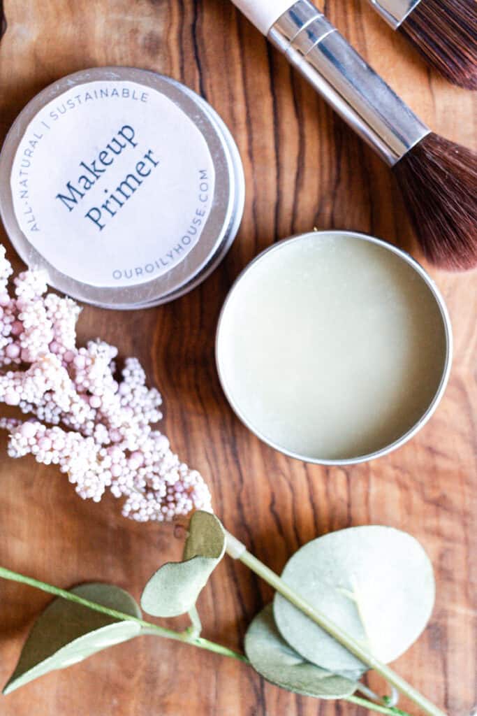 A pot of diy primer with makeup brushes.