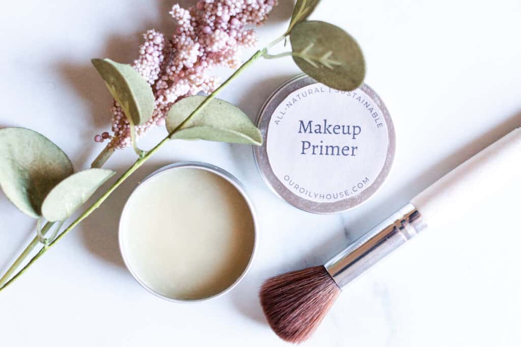 A pot of diy primer with makeup brushes.