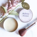 Small tin of makeup primer with an applicator brush.