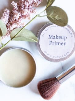 Small tin of makeup primer with an applicator brush.