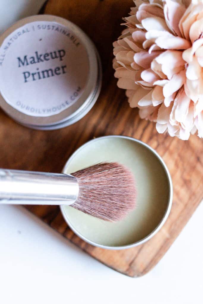 A pot of diy primer with makeup brushes.