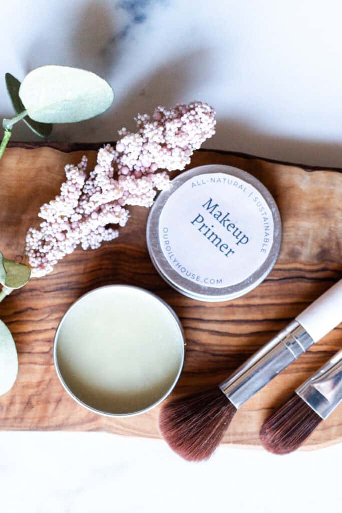 A pot of diy primer with makeup brushes.