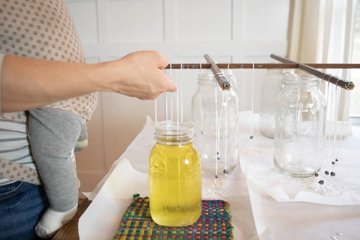 Dipping candles into hot wax 