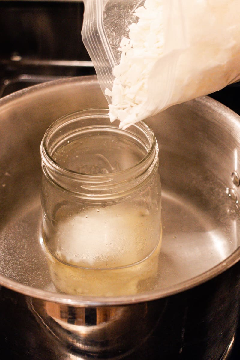 Adding wax to the double boiler.