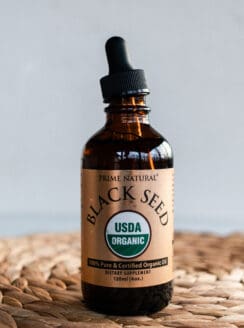 Glass bottle of black seed oil to use for strengthening hair.