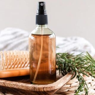How to Make Rosemary Water for Hair  6 Homemade rosemary water for hair in a glass spray bottle.