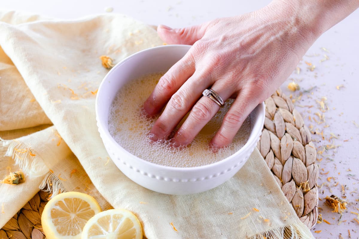 Soaking nails in homemade nail soak. 