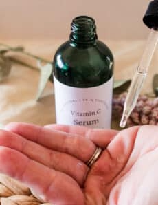 DIY vitamin C serum being warmed up in my hands.