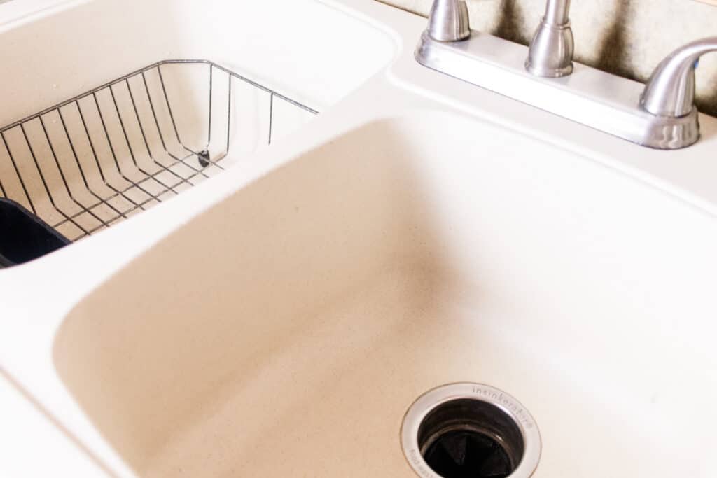 Fresh scrubbed white composite sink using a homemade cleaning solution.