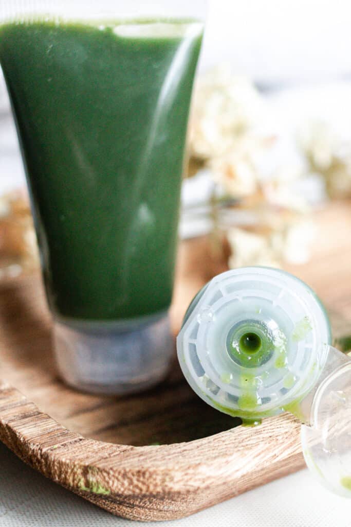 Gel face cleanser with matcha powder in a squeeze bottle.