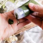 Squeezing homemade gel face cleanser onto the hand.