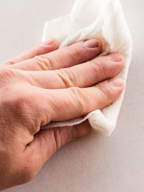 Wiping hard water stains off of white marble.