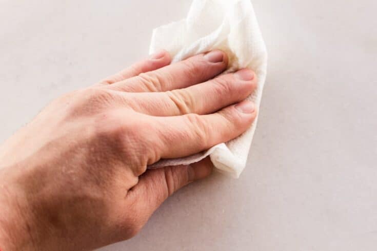 Wiping hard water stains off of white marble.
