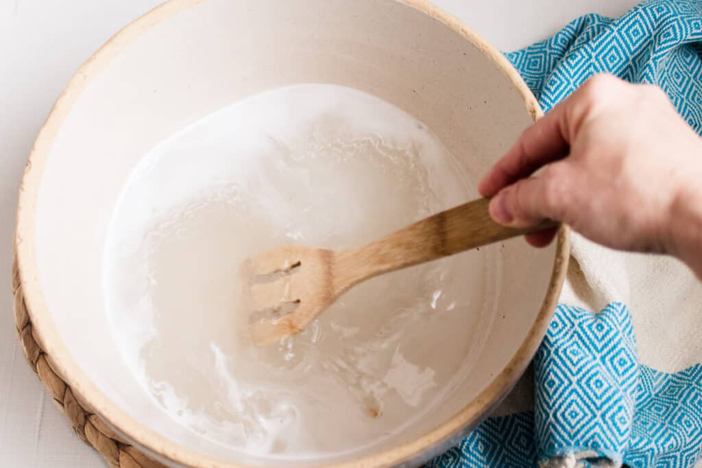 Stirring foot soak ingredients together.