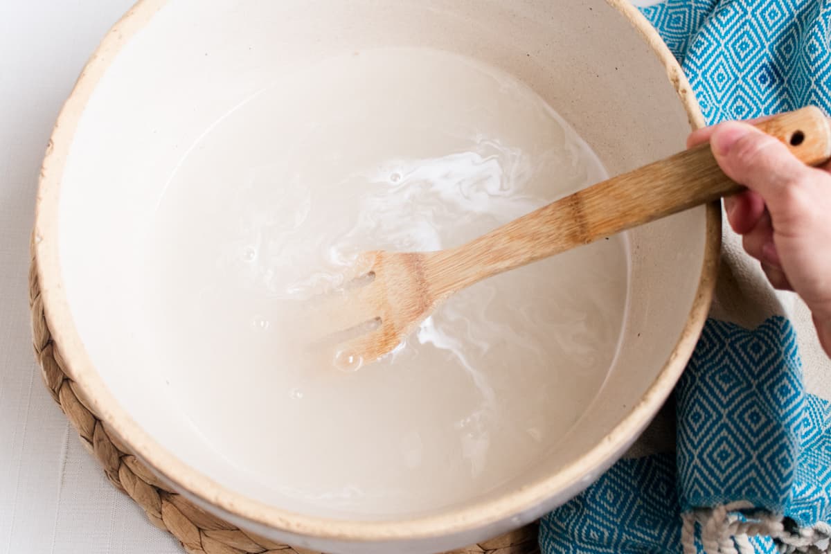 Stirring vinegar and baking soda in a bowl. 