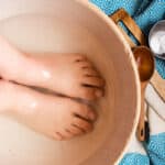 Soaking feet in a vinegar baking soda foot soak.