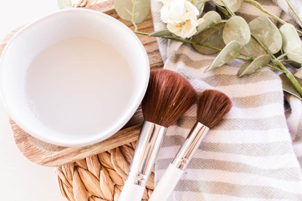 Homemade makeup brush cleaner with a towel for drying. 