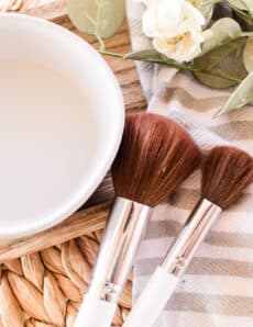 Makeup brushes drying on a striped towel.