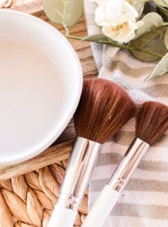 Makeup brushes drying on a striped towel.