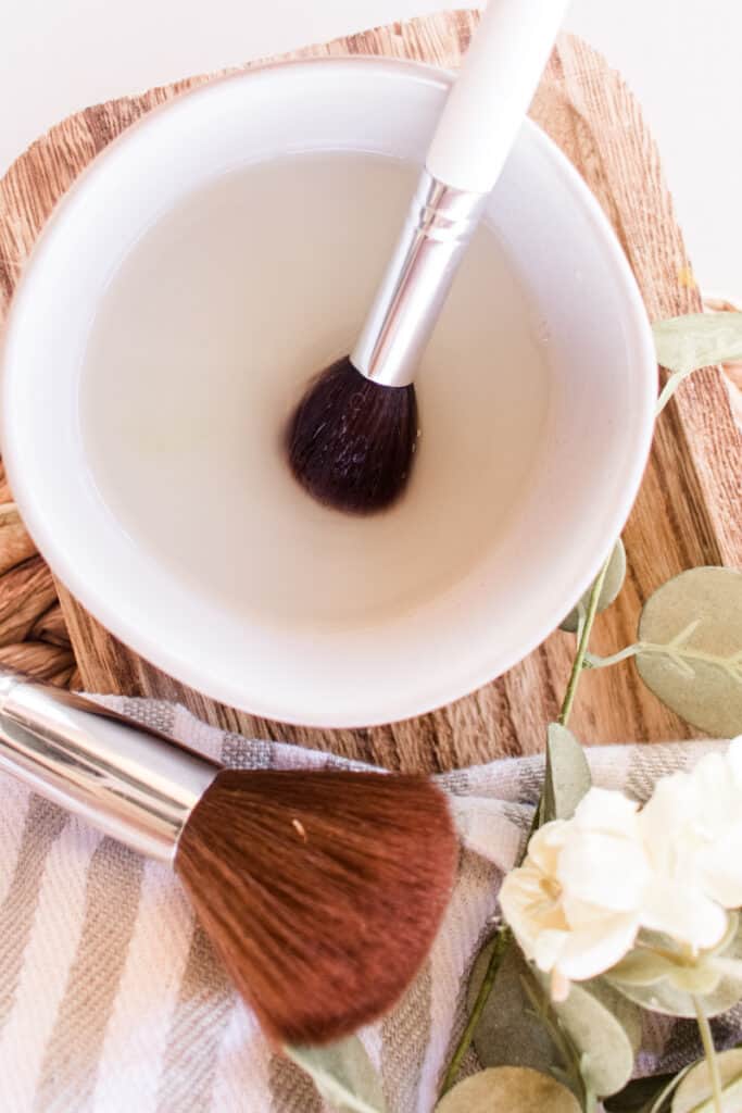 Homemade makeup brush cleaning with a white bowl. 