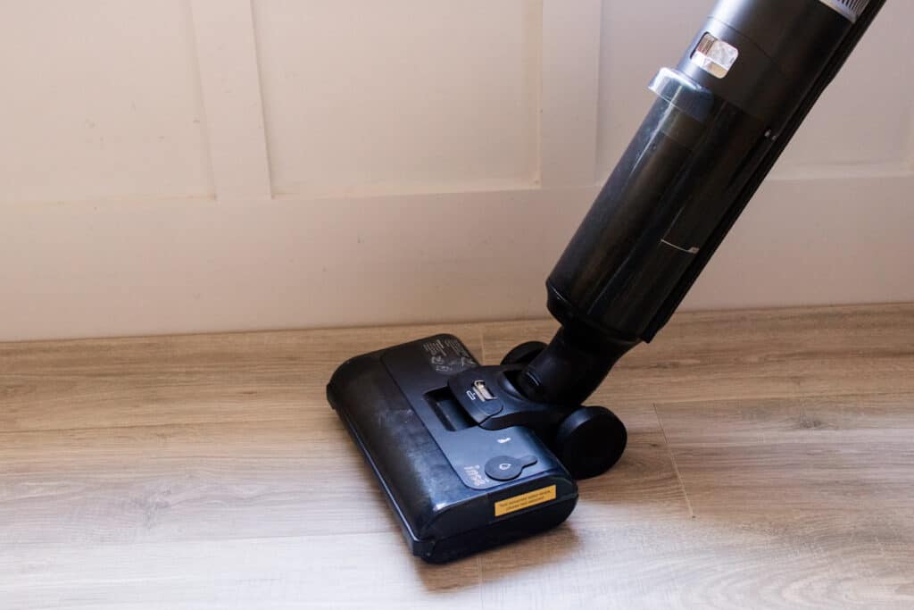 Buffing the floor with a microfiber brush vacuum roller.