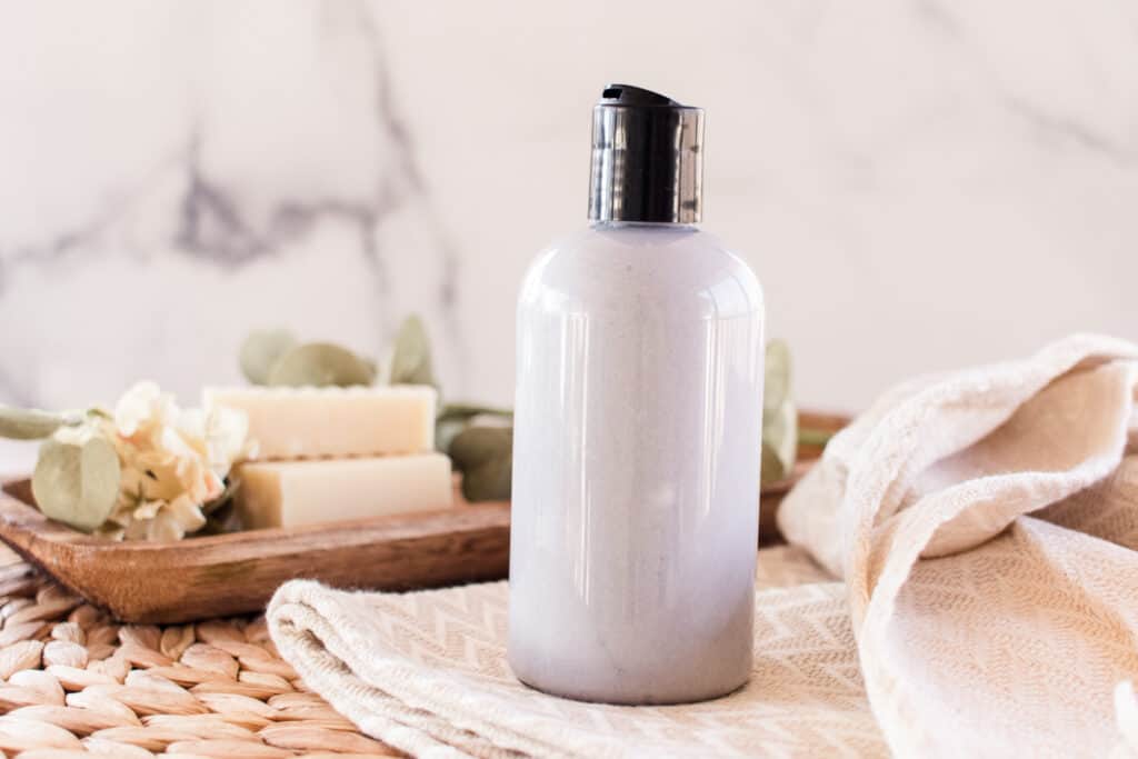 Homemade shampoo for hard water with soap behind. 