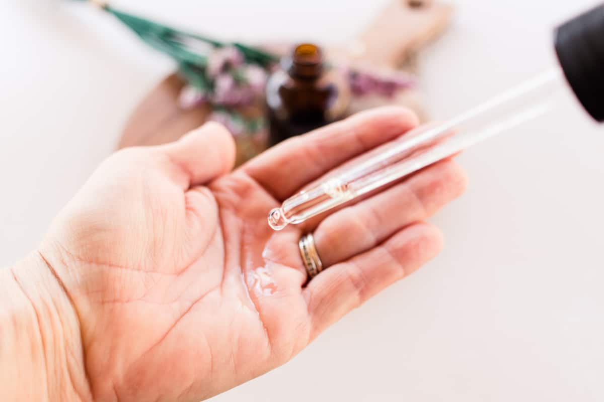 Applying a few drops of the cleansing oil to the palm of my hand. 