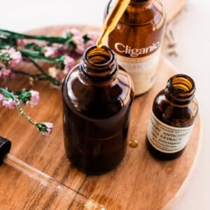Using a dropper to add oil to a cleanser bottle.