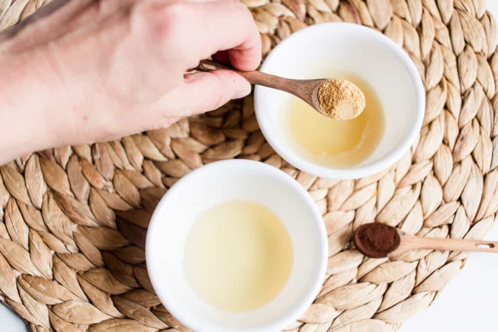 Adding lemon peel powder to the melted highlighter ingredients.