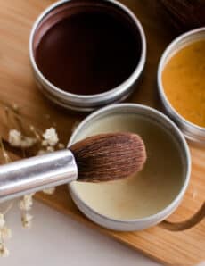 Dipping a makeup brush into a DIY highlighter recipe.