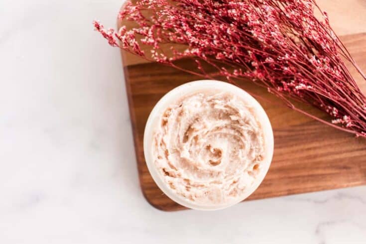 Tinted moisturizer in a glass jar with red flowers.