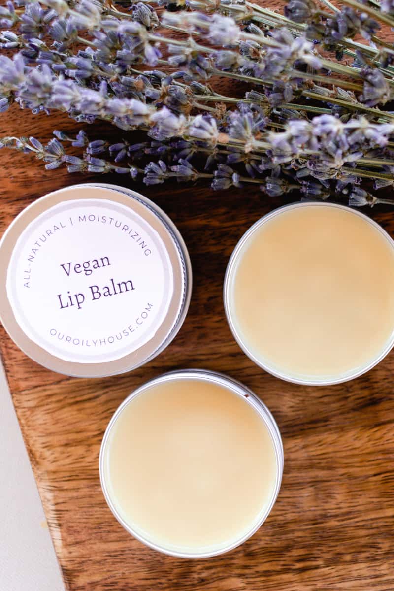 Vegan lip balms on a wooden board.