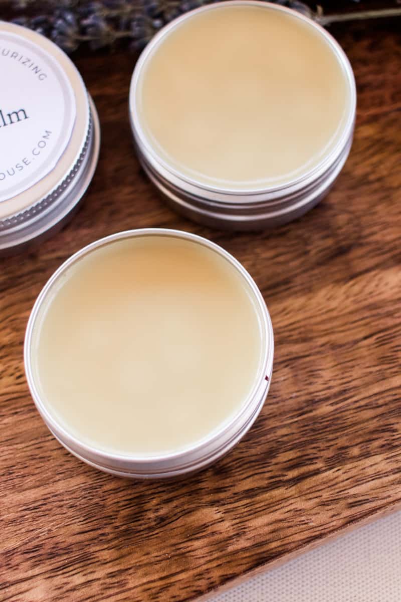 Several homemade lip balms drying in their containers.