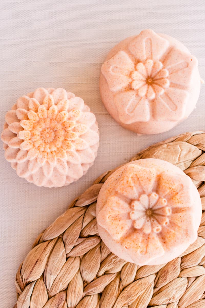 Flower design cold process soap bars on a white table.