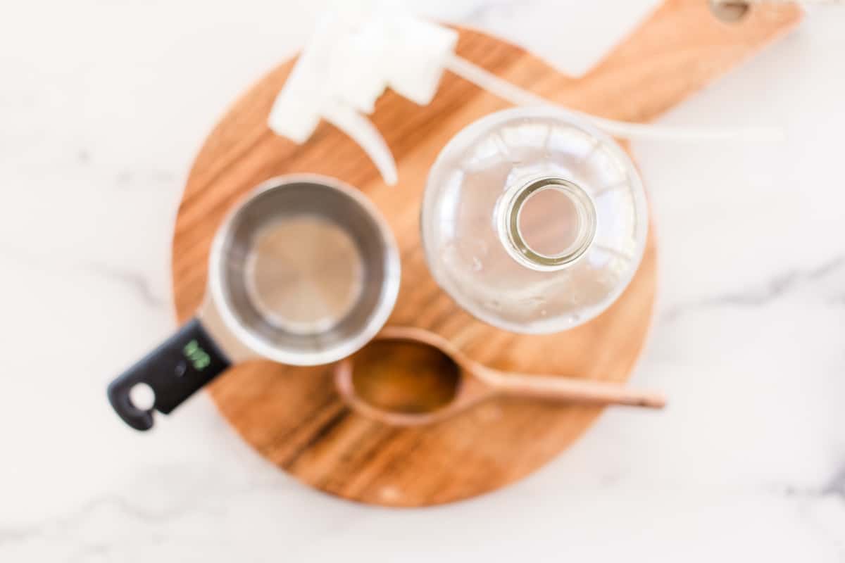 Wrinkle release spray ingredients for clothes on a wooden board.