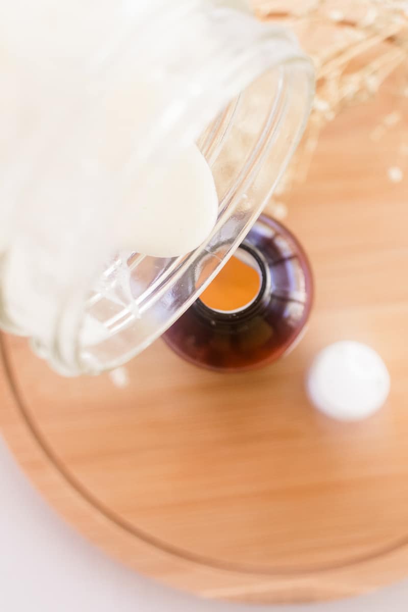 Pouring the freshly made conditioner into a small reusable container.