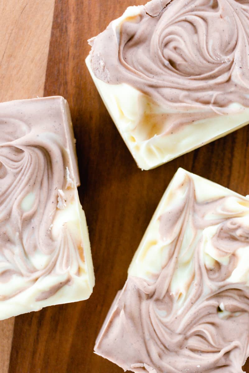 3 soap bars curing on a wooden drying rack.