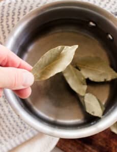 Adding bay leaves to a pot of water to boil and pour onto the hair.