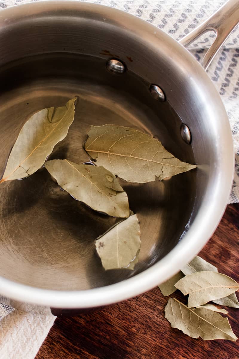 Bay leaves for hair with water simmering in a pot.
