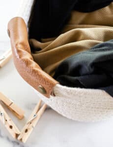 A pile of dirty workout clothes sitting in a hamper.