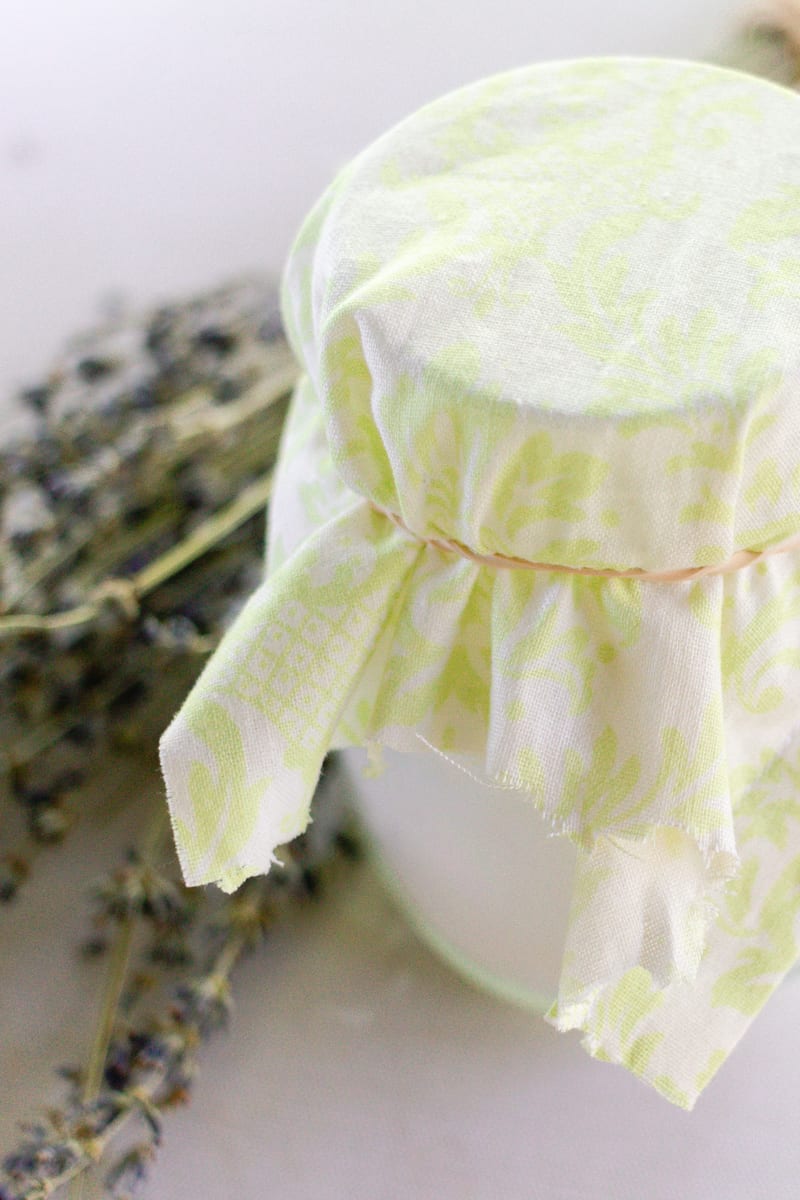 A jar of baking soda to absorb odors in a musty closet with a breathable cloth on top.