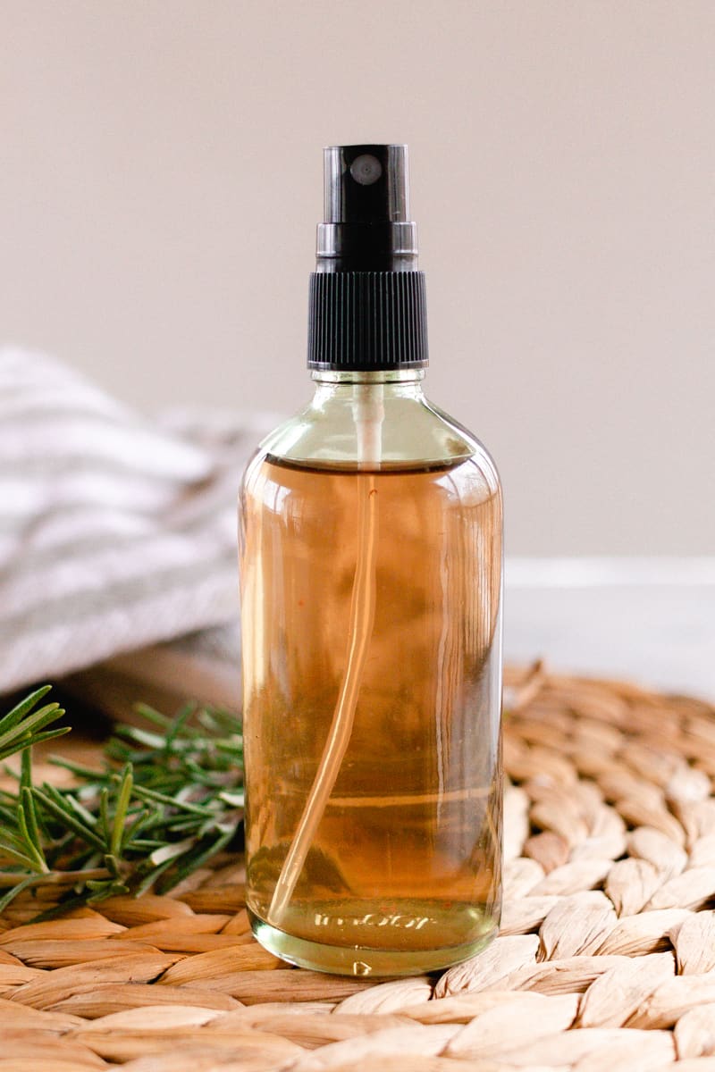 Rosemary water in a glass spray bottle.