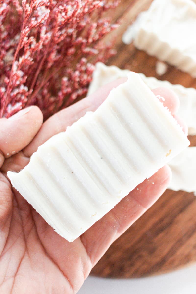 Holding a shea butter soap bar.