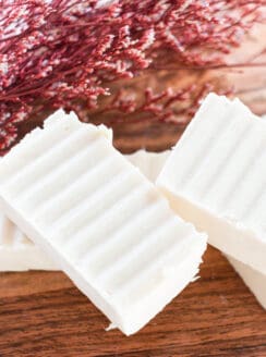 Hand cut homemade shea butter soap bars sitting on a wooden table.